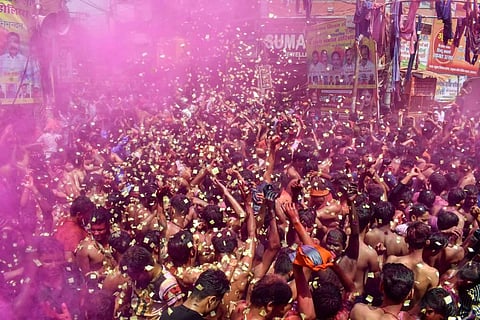 People celebrate Holi as they gather in large numbers, amid a countrywide spike in coronavirus cases, in Prayagraj, Monday, March 29, 2021. (Photo | PTI)