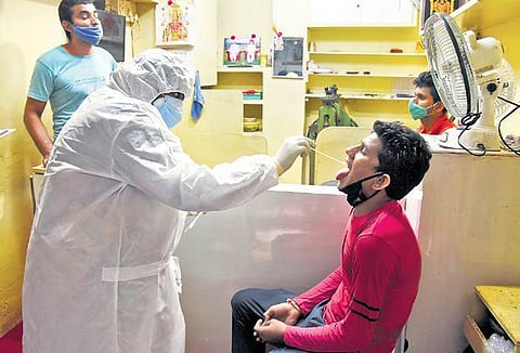 A healthcare worker collects swab sample at George Town | R Satish Babu