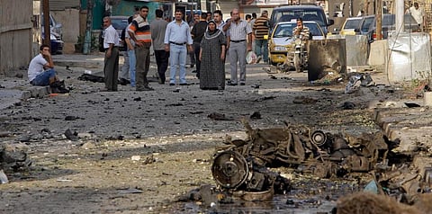 In this November 1, 2010 file photo, Iraqis inspect the scene of a car bomb attack in front of a Our Lady of Salvation Church in Baghdad, in Baghdad, Iraq. (Photo | AP)