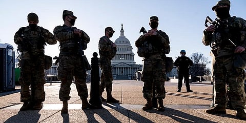 Members of the Michigan National Guard and the U.S. Capitol Police keep watch as heightened security remains in effect around the Capitol grounds. (Photo | AP)