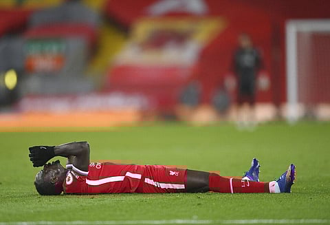 Liverpool's Sadio Mane lies on the field during the English Premier League soccer match between Liverpool and Chelsea at Anfield stadium in Liverpool. (Photo | AP)