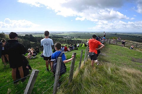 People watch for signs of a tsunami from a hill above Papamoa Beach, New Zealand, as a tsunami warning is issued Friday, March 5, 2021. (Photo | AP)