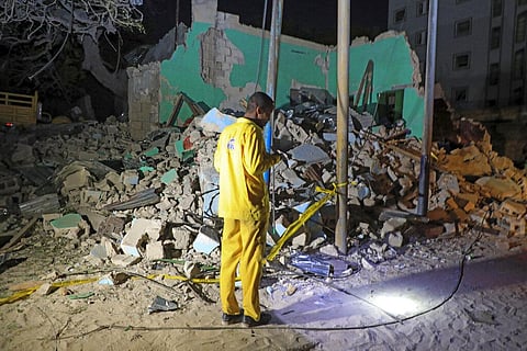 A man observes a destroyed building at the scene of a blast at a popular restaurant in the capital Mogadishu. (Photo| AP)