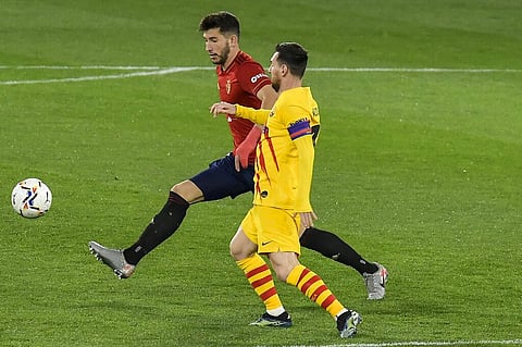 Barcelona's Lionel Messi, right, vies for the ball with Osasuna's Jonathan Calleri during the Spanish La Liga soccer match between Osasuna and FC Barcelona. (Photo | AP)