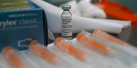 A vial of the AstraZeneca coronavirus vaccine ready for use during the pilot project of pop up vaccination drive 'Vaxi Taxi' in London. (Photo | AP)