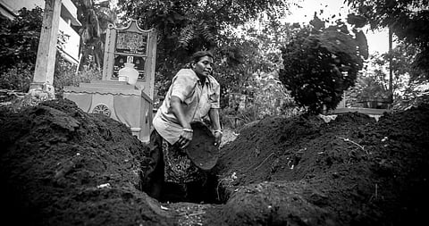 P Seetha burying a body at the TVS Burial Ground in Salem. (Photo | Special Arrangement)