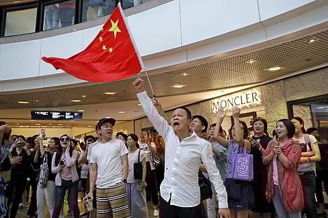 Pro-China supporters wave a Chinese national flag in a shopping mall in Hong Kong, Wednesday. (Photo | AP)