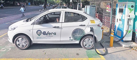 An electric vehicle is connected to a charging station at Rafi Marg on Wednesday | SHEKHAR YADAV