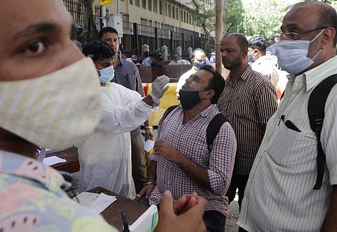 A health worker takes a nasal swab sample to test for COVID-19 outside a court in Mumbai, India, Wednesday, March. 31, 2021. (Photo | AP)