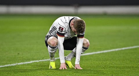 Germany's Timo Werner reacts disappointed on the grass after he missed a big chance to score during the World Cup 2022 group J qualifying soccer match. (Photo | AP)