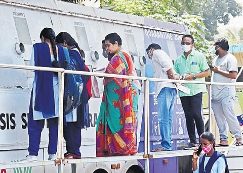 People wait in front of a mobile unit to get tested for Covid-19 at Vijayawada Railway Station on Wednesday | P Ravindra Babu