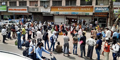 People stand in a queue at a drug store in Madhya Pradesh. (Photo | ANI)