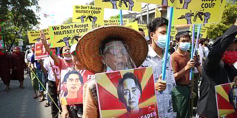 Protesters shout slogans and display images of deposed Myanmar leader Aung San Suu Kyi during an anti-coup protest march in Mandalay, Myanmar. (Photo | AP)