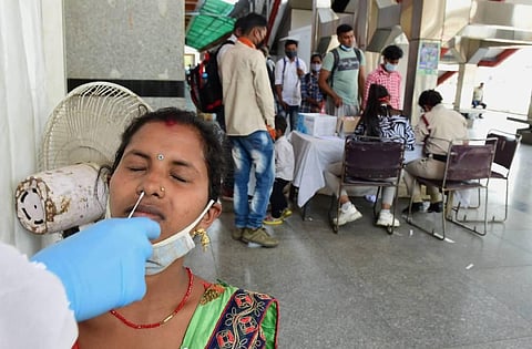 Passengers being tested for COVID-19 at a train station, amid rise in coronavirus cases, in New Delhi. (Photo | PTI)