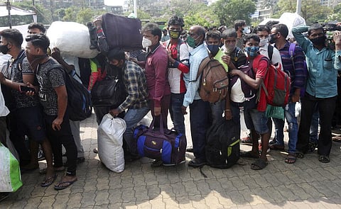 People wearing masks stand in a queue for a train at Lokmanya Tilak Terminus in Mumbai. (Photo | AP)