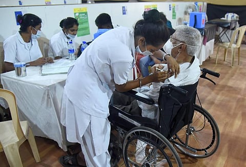 A medic vaccinates a person with a physical diaability during an inoculation drive, as coronavirus cases surge in Mumbai. (Photo | PTI)