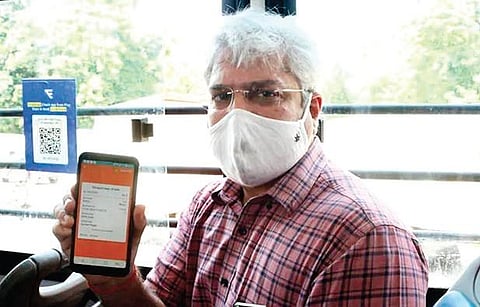 Delhi Transport Minister Kailash Gahlot shows the chartr app for e-ticketing | File