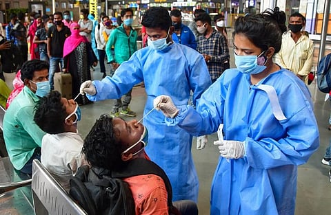 Health workers take swab samples of passengers at Chhatrapati Shivaji Maharaj Terminus Railway Station. (Photo | PTI)