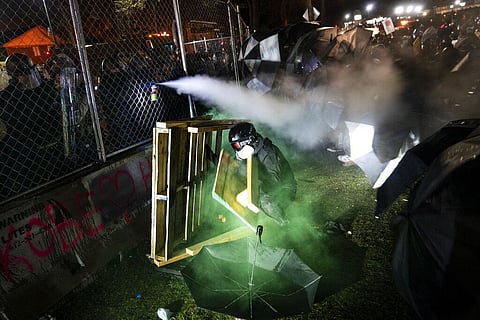 A demonstrator is shot with less-than-lethal marking rounds and tear gas during a standoff with police during a protest decrying the shooting death of Daunte Wright. (Photo | AP)