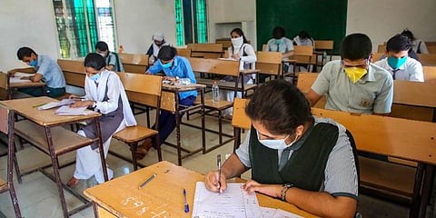 Students wearing protective masks appear in the higher secondary school examination. (File Photo | PTI)