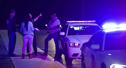 A woman asks law enforcement near the FedEx hub following a shooting in Indianapolis. (Photo | AP)