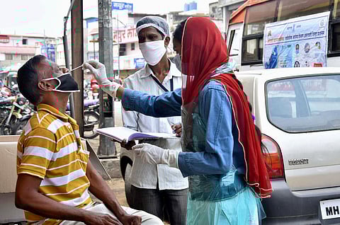 A health worker collects samples for COVID-19 testing, amid surge in coronavirus cases, in Amravati, Maharashtra, Friday, April 16, 2021. (Photo | PTI)
