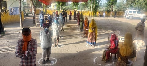Voters waiting in line at a polling booth at Sahada Assembly seat.
