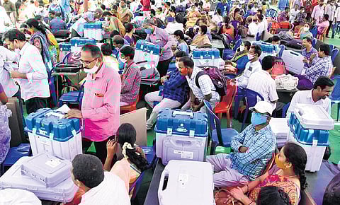 Polling staff check electronic voting machines at the distribution centre at the SV Arts College grounds in Tirupati on Friday | Madhav K