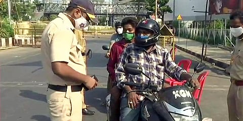 Police personnel check vehicles near Marine Drive as strict restrictions have been imposed in Mumbai. (Photo| ANI)