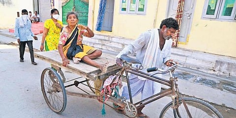 An elderly woman arrives at a polling booth on a cart to exercise her franchise. (Photo | EPS) 