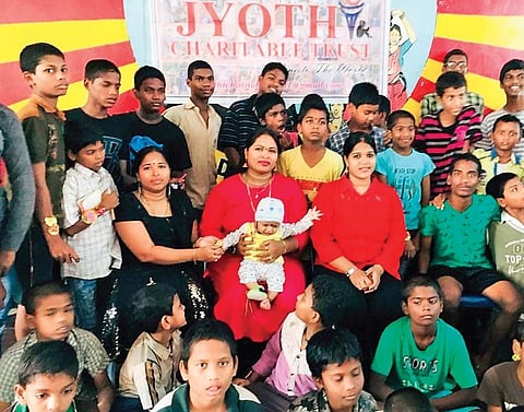 Jyothi poses with school students in Vijayawada | Express 