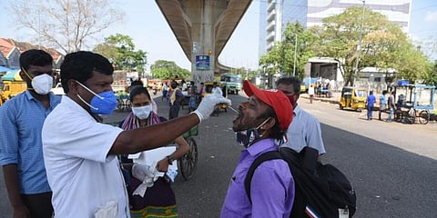Health workers doing swab test on a traveller at Koyembedu, in Chennai. (Photo |  R Satish Babu, EPS)