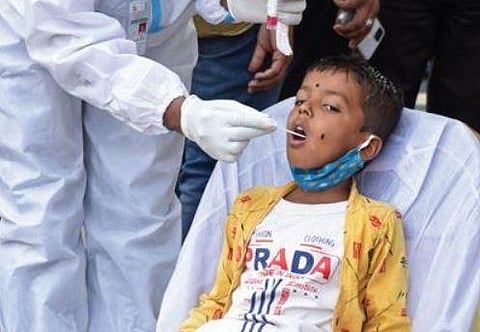 A health worker collects swab samples of a boy at Majestic on Saturday | Vinod Kumar T