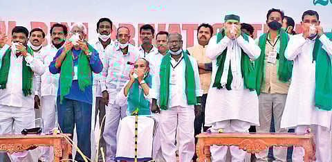 Farmer leaders blowing conches before the start of sankharavam at RK beach in Visakhapatnam on Sunday | Express