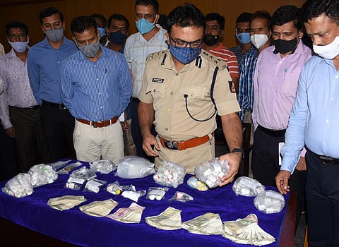 Mysuru police commissioner Dr Chandragupta seen with fake Remdesivir vials that were recovered from the accused in Mysuru on Monday (Express Photo | Udayshankar S)
