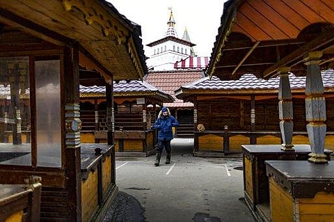 A security worker walks through an empty market near a boutique hotel called Skazka – or 'Fairytale' -- in eastern Moscow. (Photo | AP)