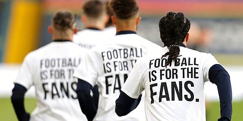 Leeds United players wear t-shirts with the logo 'Football Is For The Fans' as they warm-up ahead of ahead of the EPL match against Liverpool. (Photo | AP)