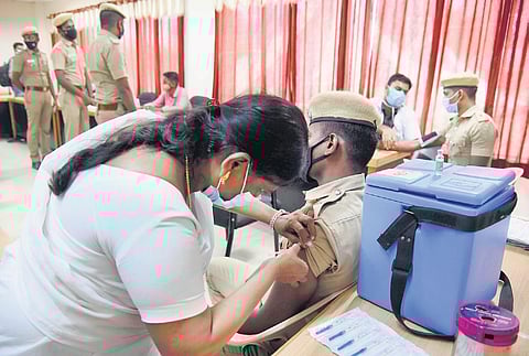 A policeman getting vaccinated at Rajarathinam Stadium, in Chennai,  on Monday. (Photo | R Satish Babu/EPS)