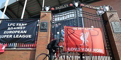 A man cycles past banners outside of Anfield Stadium, Liverpool, England protesting against the clubs decision to join the European Super Leaguer. (Photo | AP)