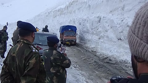 A civil trucks, carrying essential fresh supplies moves along the ZojiLa Pass towards Kargil. (Photo | Special arrangement)