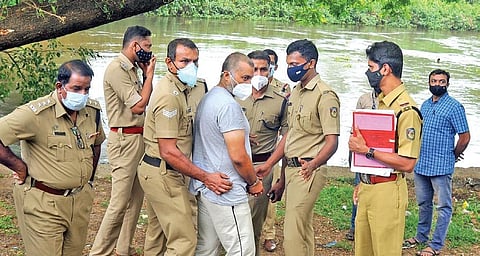 Police team taking Sanu Mohan for evidence collection on the banks of the Muttar on Tuesday | A Sanesh