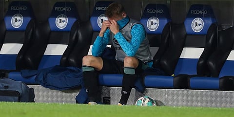 Schalke 04 defender Timo Becker sits alone on the bench after the German Bundesliga soccer match at Schueco Arena in Bielefeld. (Photo | AP)