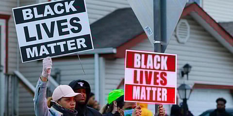 Demonstrators gather a the corner of Templar Street and Legion Lane following a fatal police shooting on Tuesday. (Photo | AP)