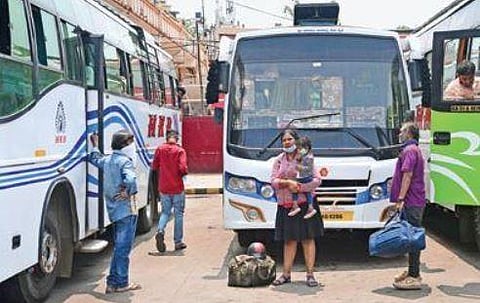 Passengers wait to board private buses in Majestic, in the wake of the transporters’ strike, in Bengaluru on Tuesday | Express