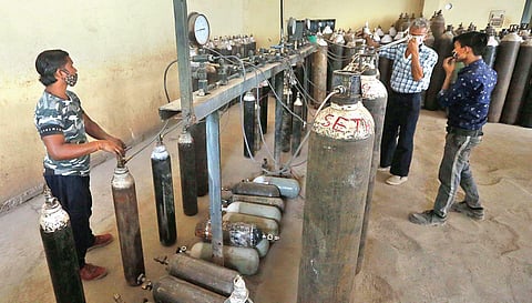 Workers fill cylinders with medical oxygen at an oxygen plant in New Delhi on Wednesday amidst a countrywide surge in new Covid-19 cases | Shekhar Yadav
