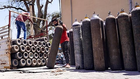 Workers sort oxygen cylinders, being used for Covid-19 patients (Photo |  PTI)