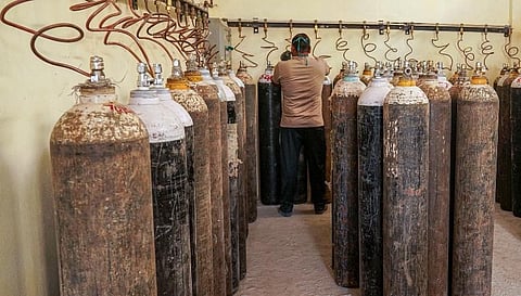 A worker sorts medical oxygen cylinders meant for Covid-19 patients (Photo | PTI)