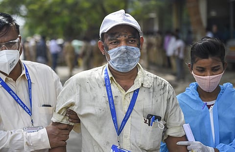 Health workers evacuate employees of  Vijay Vallabh COVID care hospital after a fire in Virar West. (Photo | PTI)