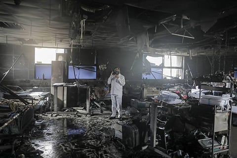 Maharashtra state Minister Eknath Shinde at the site of the fire at a Covid-19 hospital, where at least 13 patients died, in Virar. (Photo | PTI)