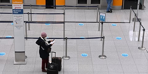 A woman stands in front of counters in a terminal of the Franz-Josef-Strauss airport in Munich, southern Germany. (File photo| AFP)